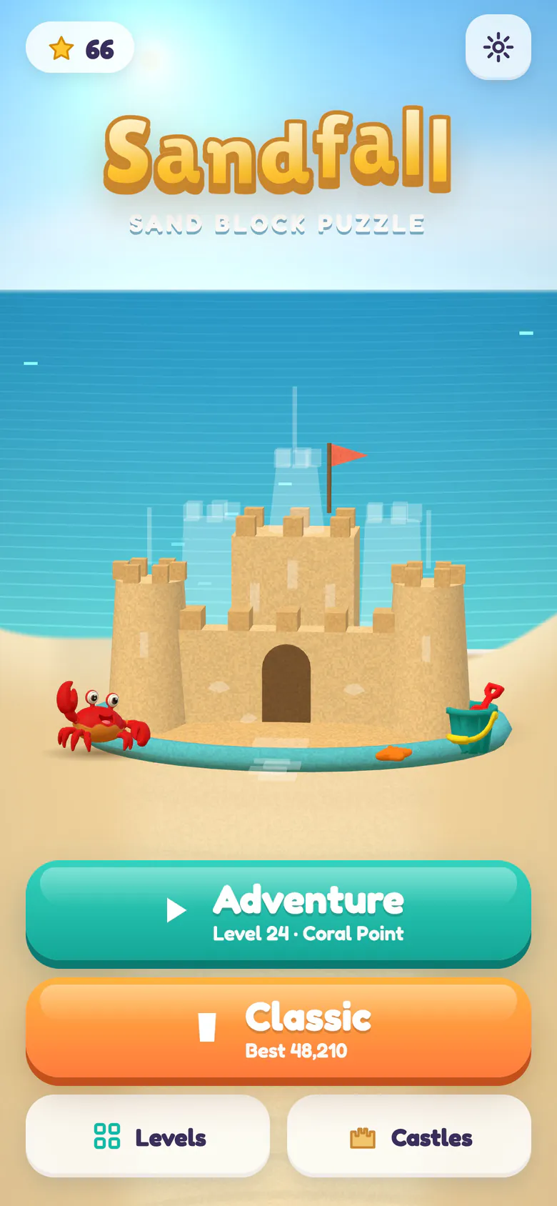 Sandfall home screen: the logo above a sunny beach, a half-built sandcastle with a moat and faint outlines of the towers still to come, a red crab and a bucket and spade, with the Adventure button for level 24 at Coral Point and the Classic button.
