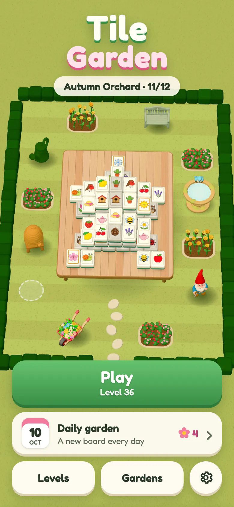 Tile Garden home screen: the logo above the Autumn Orchard at 11 of 12 treasures, a garden table holding the next board of picture tiles, flower beds, a gnome, a beehive, a birdbath and a wheelbarrow inside a hedge, the Play button for level 36 and the daily garden card.